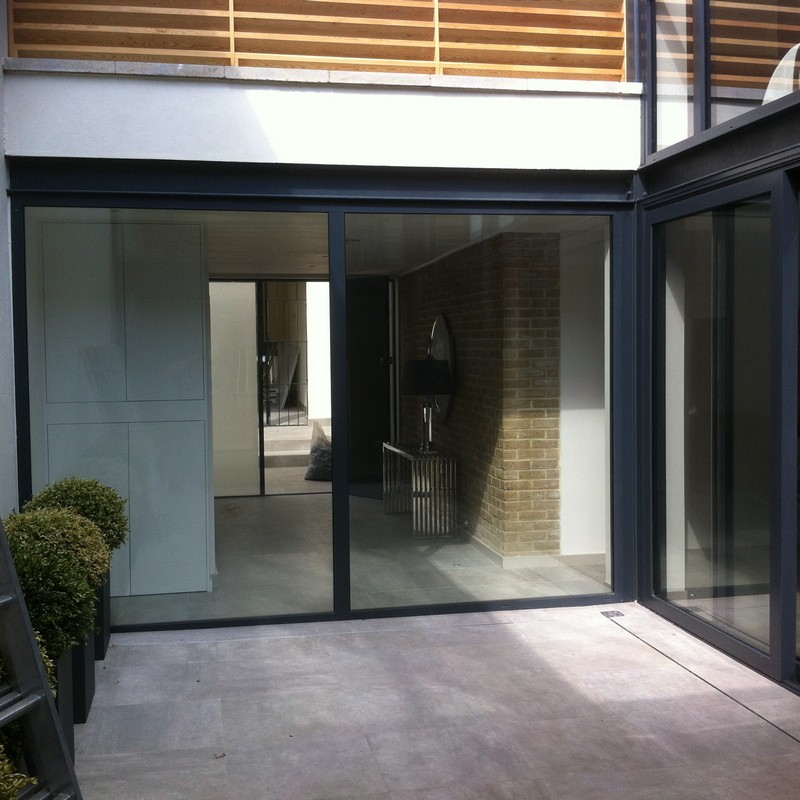 Floor-to-ceiling sliding doors opening to courtyard in Seven Sisters