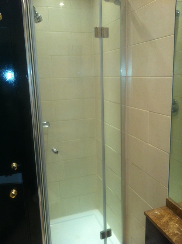 Frameless glass shower enclosure with chrome fittings in Seven Sisters